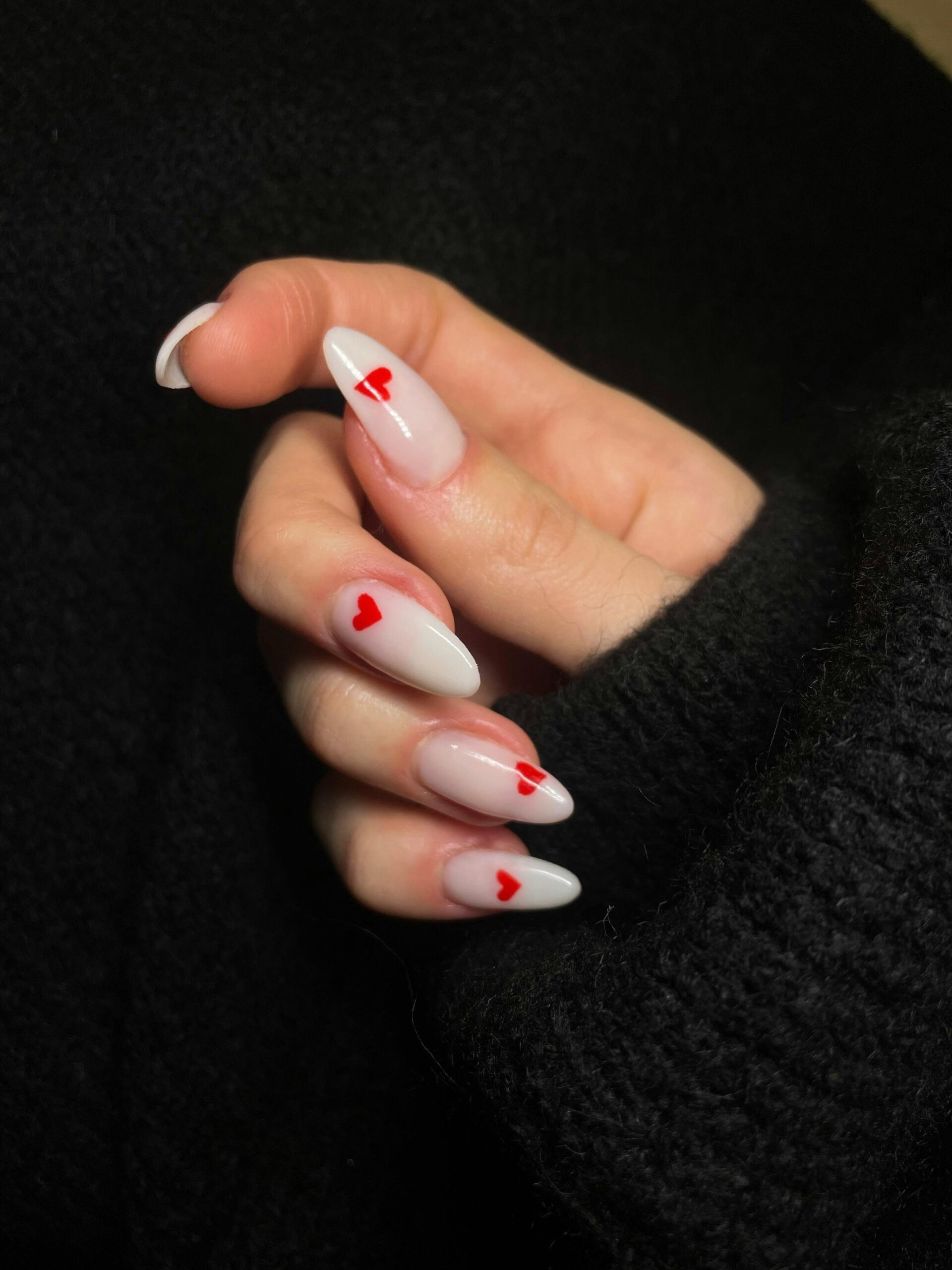 Close-up of Acrylic Nails Decorated with Heart Shapes